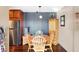 Charming dining area with wood table and chairs, and a modern light fixture at 3965 N Meridian St # Apt 6C, Indianapolis, IN 46208