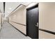 Long hallway with carpeted floor and neutral-colored walls at 3965 N Meridian St # Apt 6C, Indianapolis, IN 46208