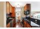 Galley kitchen with granite countertops and hardwood floors at 3965 N Meridian St # Apt 6C, Indianapolis, IN 46208