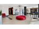 Lobby with red seating, modern light fixture and plants at 3965 N Meridian St # Apt 6C, Indianapolis, IN 46208