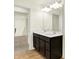 Bathroom with double vanity, modern lighting, and wood-look flooring at 4103 Railhead Ave, Westfield, IN 46074