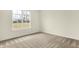 Bright, carpeted bedroom with a large window overlooking a lush backyard, providing natural light at 4103 Railhead Ave, Westfield, IN 46074