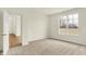 A cozy carpeted bedroom featuring an open doorway to the hallway and a view from the window at 4103 Railhead Ave, Westfield, IN 46074