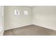Clean bedroom with carpet flooring, neutral walls, and natural light from two windows at 4103 Railhead Ave, Westfield, IN 46074