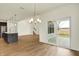 Bright dining area showcasing wood floors, modern chandelier, and a sliding glass door to patio at 4103 Railhead Ave, Westfield, IN 46074
