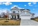 Charming two-story home featuring a two-car garage, covered porch, and gray siding with white trim at 4103 Railhead Ave, Westfield, IN 46074