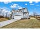 Side view of home with a two-car garage, landscaping, and a well-manicured lawn at 4103 Railhead Ave, Westfield, IN 46074