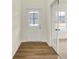 Bright entryway with wood floors, a white door, and a glimpse into a sunlit room through glass doors at 4103 Railhead Ave, Westfield, IN 46074