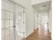 Hallway with wood floors leads to an open room framed by glass doors and a glimpse of the kitchen at 4103 Railhead Ave, Westfield, IN 46074