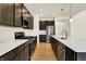 Kitchen featuring quartz countertops, modern appliances, and dark wood cabinets at 4103 Railhead Ave, Westfield, IN 46074