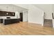 Bright open-concept living room featuring hardwood floors and a view of the kitchen and staircase at 4103 Railhead Ave, Westfield, IN 46074