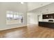 Bright open-concept living room featuring hardwood floors and a view of the kitchen and backyard at 4103 Railhead Ave, Westfield, IN 46074