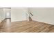 Open living room with hardwood floors, stairs, and a view of the front door with glass accents at 4103 Railhead Ave, Westfield, IN 46074