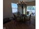 Bright dining area with glass table, chandelier, and view of backyard at 4175 Bozeman Way, Bargersville, IN 46106