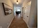 Bright hallway with hardwood floors and a view of the living room at 4175 Bozeman Way, Bargersville, IN 46106