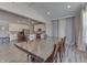 Open concept dining room with kitchen view, hardwood floors, and a large wooden table at 4223 Mardale Ln, Bargersville, IN 46106