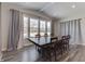 Spacious dining area with large windows, hardwood floors, and a rustic farmhouse table at 4223 Mardale Ln, Bargersville, IN 46106