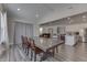 Open concept dining room with kitchen and living room views, hardwood floors, and a large table at 4223 Mardale Ln, Bargersville, IN 46106