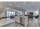 Open concept kitchen with island, stainless steel appliances, and views to the dining and living areas at 4223 Mardale Ln, Bargersville, IN 46106
