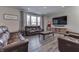 Spacious living room with brown leather reclining sofas, large TV, and hardwood floors at 4223 Mardale Ln, Bargersville, IN 46106