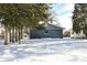 Rear view of gray house with stone siding and snowy yard at 435 Belmar Ave, Indianapolis, IN 46219