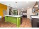 Bright kitchen with green island, stainless steel appliances, and wood flooring at 4351 Ringstead Way, Indianapolis, IN 46235