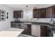 Modern kitchen with dark cabinetry, stainless steel appliances, and granite countertops at 4556 Plowman Dr, Indianapolis, IN 46237