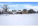 House exterior and expansive snowy backyard at 457 S High School Rd, Indianapolis, IN 46241