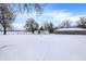 Snowy backyard with storage sheds and a chain link fence at 457 S High School Rd, Indianapolis, IN 46241