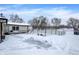 Backyard patio area covered in snow with a chain link fence at 457 S High School Rd, Indianapolis, IN 46241