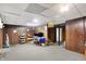 Finished basement with wood paneled walls and carpeted floor at 457 S High School Rd, Indianapolis, IN 46241