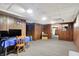 Finished basement with wood paneled walls and carpeted floor at 457 S High School Rd, Indianapolis, IN 46241