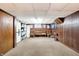 Finished basement area with rocking chairs and built-in shelving at 457 S High School Rd, Indianapolis, IN 46241
