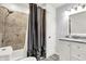 Bathroom featuring a shower/tub combo, tile surround, and gray curtain at 457 S High School Rd, Indianapolis, IN 46241