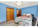 Bedroom with light blue walls, hardwood floors, and double doors leading to a closet at 457 S High School Rd, Indianapolis, IN 46241