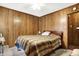Bedroom with wood paneled walls and hardwood floors at 457 S High School Rd, Indianapolis, IN 46241