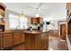 Kitchen with wood cabinets, granite island, and hardwood floors at 457 S High School Rd, Indianapolis, IN 46241