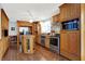 Bright kitchen with oak cabinets, stainless steel appliances, and an island at 457 S High School Rd, Indianapolis, IN 46241