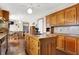 Kitchen with wood cabinets, granite island, and hardwood floors at 457 S High School Rd, Indianapolis, IN 46241