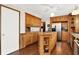 Kitchen features oak cabinets, stainless steel appliances, and an island at 457 S High School Rd, Indianapolis, IN 46241