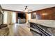 Main bedroom with wood wall, ceiling fan, and access to patio at 457 S High School Rd, Indianapolis, IN 46241