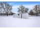 Two storage sheds in a snowy backyard at 457 S High School Rd, Indianapolis, IN 46241