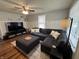 Living room with sectional sofa, ottoman, and hardwood floors at 5140 Sunny Meade Ln, Indianapolis, IN 46208