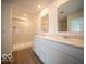 Bathroom showcasing a glass-door shower, double vanity with sink, and large mirror at 6039 Granby Dr, Whitestown, IN 46075