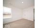 Bright bedroom features a large window for natural light and neutral carpet flooring at 6039 Granby Dr, Whitestown, IN 46075