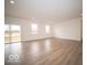Spacious living room featuring hardwood floors, neutral walls, sliding glass doors, natural light, and open layout at 6039 Granby Dr, Whitestown, IN 46075