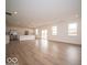 Bright and open living area featuring hardwood floors, recessed lighting, a kitchen with a large island, and natural light at 6039 Granby Dr, Whitestown, IN 46075
