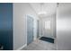 Bright entryway with gray walls, tiled floor, and blue doors at 6041 Prairie Stream Way, Columbus, IN 47203