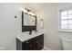 Modern bathroom with dark vanity, updated fixtures, and a window at 6346 E County Road 100 S, Avon, IN 46123