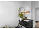 Stylish bathroom featuring a black vanity with gold accents and a round mirror at 6471 Homestead Dr, Indianapolis, IN 46227